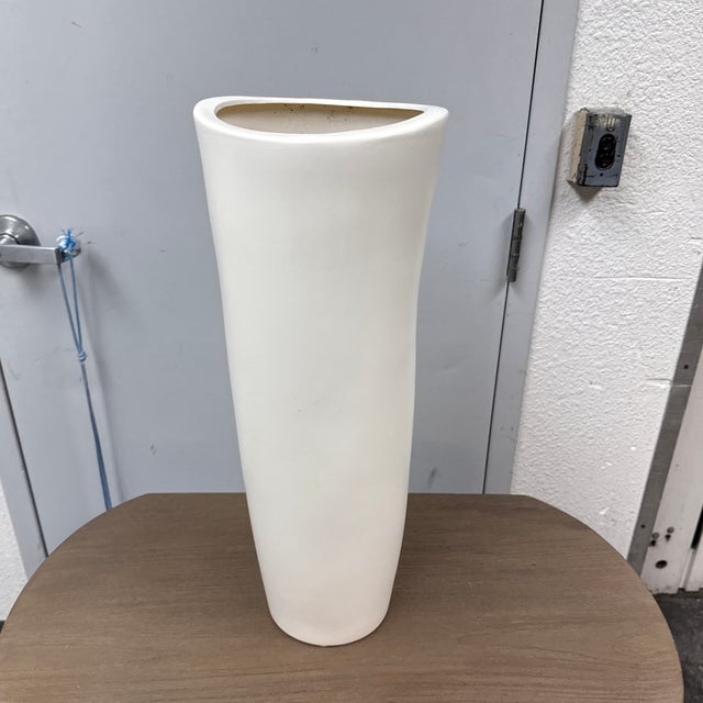 Design Plus Gallery presents a Calcium Floor Vase. This CB2 floor vase has a tall cylindrical form with a matte white...