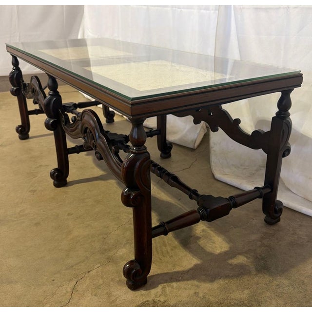 An exceptional, genuine antique Spanish Baroque-style mahogany vitrine coffee table featuring a masterfully carved low...