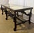 An exceptional, genuine antique Spanish Baroque-style mahogany vitrine coffee table featuring a masterfully carved low...
