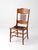 A striking late 19th-century Victorian Eastlake chair featuring beautifully carved oak leaf details, turned spindle...