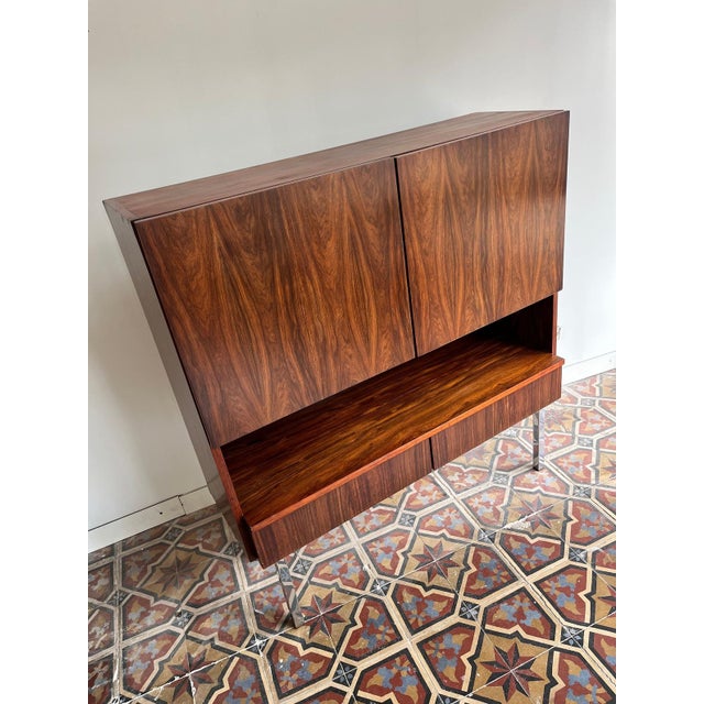 Rosewood highboard. Thanks to its striking grain, it’s always a stylish eye-catcher in any interior. manufacturer: unknown...