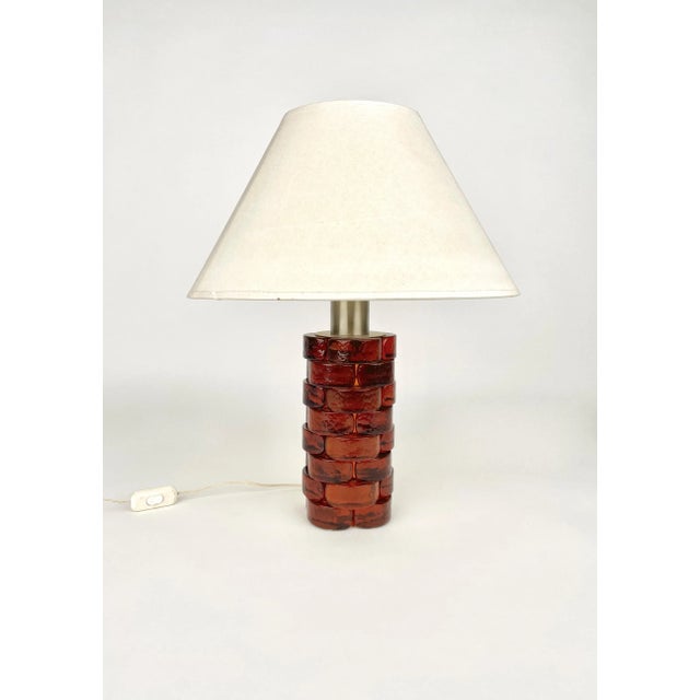 Two-lights table lamp in amber glass and metal by Poliarte. Made in Italy in the 1970s. Measures: Height without...