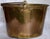 You can tell this brass bucket was used at some time for a special purpose. The dents on the bottom are attempting to tell...