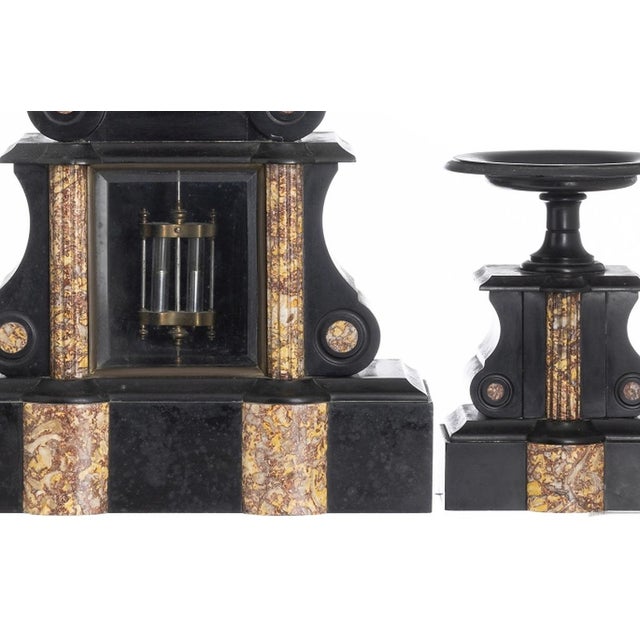 Clocks - Garniture - 19th Century. French; 19th century (4th quarter). Composed of chandeliers and a table clock in black...