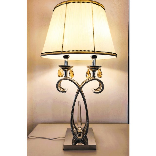 An elegant pair of table lamps by Gallo Design (Italy, ca. 2000), featuring a sculptural chrome-plated metal frame and...