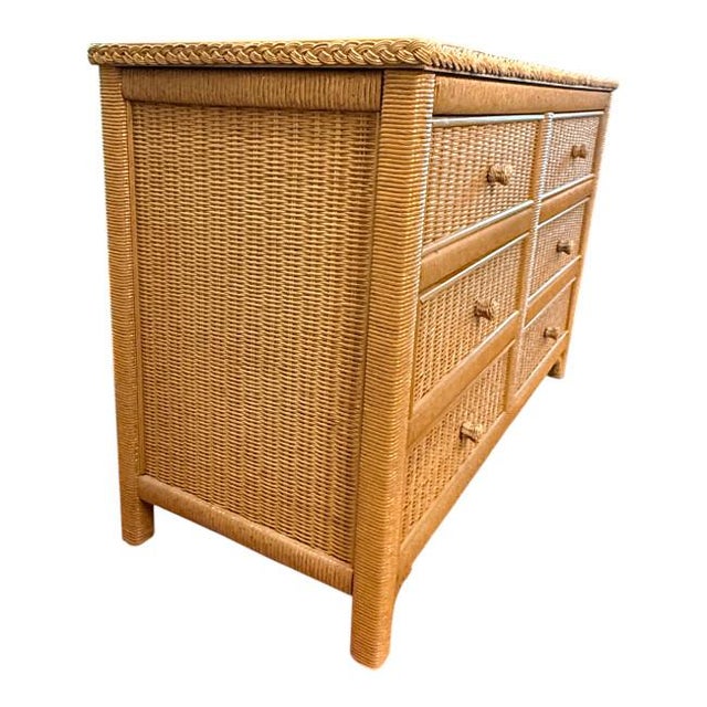 Beautiful vintage wicker dresser by Henry Link, featuring a warm honey-tan finish and intricate woven rattan detailing....
