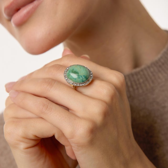 A bold and expressive statement from the 1980s, this striking cocktail ring centers on a luminous cabochon turquoise with...