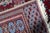A captivating antique Uzbek Bukhara rug from the 1920s, showcasing the distinctive geometric artistry of Central Asian...