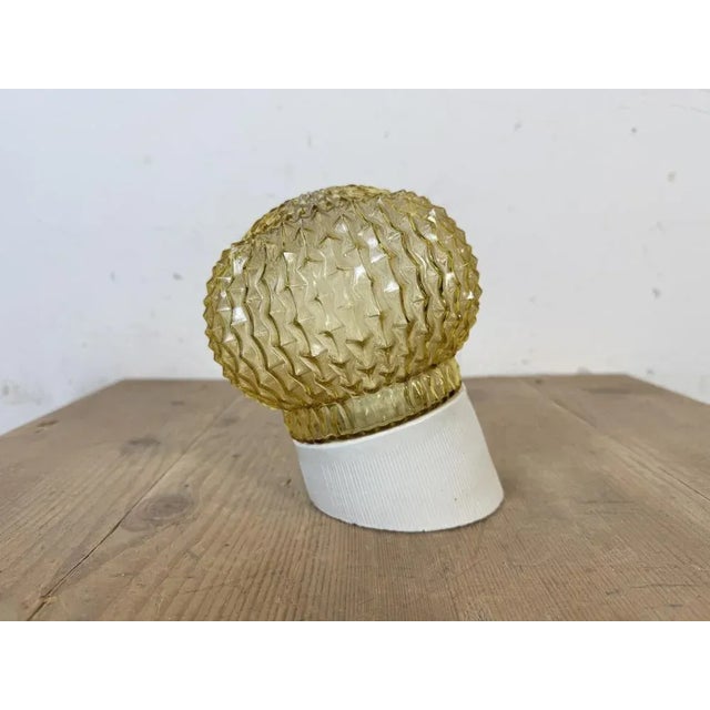 Vintage industrial light made in former Czechoslovakia the 1970s. It features a white porcelain wall mounting and a glass...