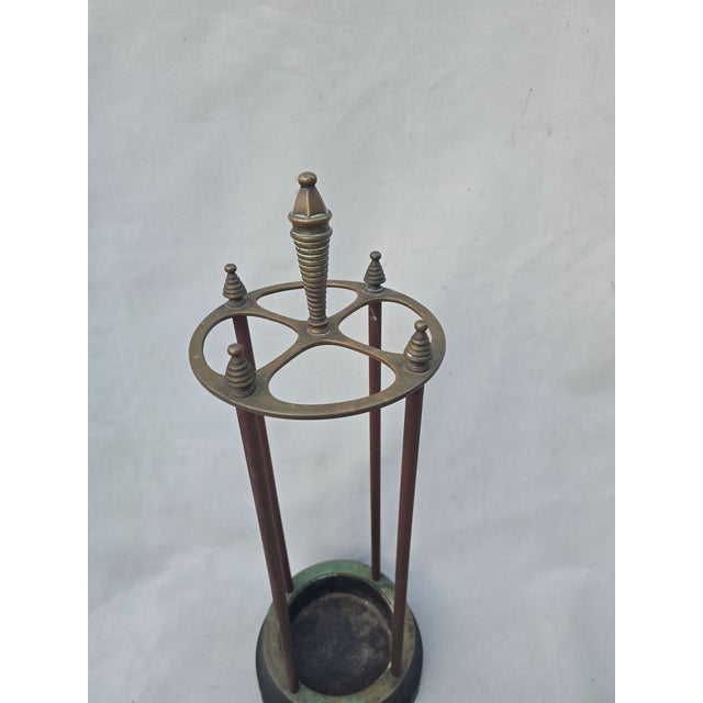 This is a vintage art deco brass and metal umbrella holder. This could also be used to hold fireplace tools, walking canes...