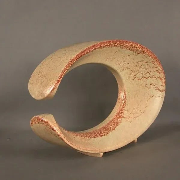 This Ceramic Vase was designed by Bertoncello, Italy 1950ies. It has an organic C-shape with one round opening. It stands...