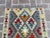 Add a splash of vibrant color to your living space with this colorful handwoven wool kilim rug. Featuring a stunning...