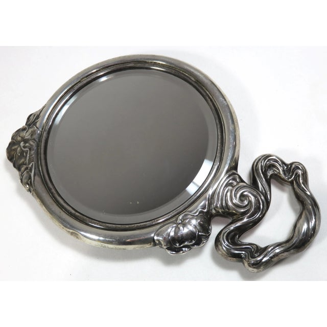 This is an exceptionally nice antique sterling silver hand mirror - ladies vanity mirror. It is done in a fancy - repousse...