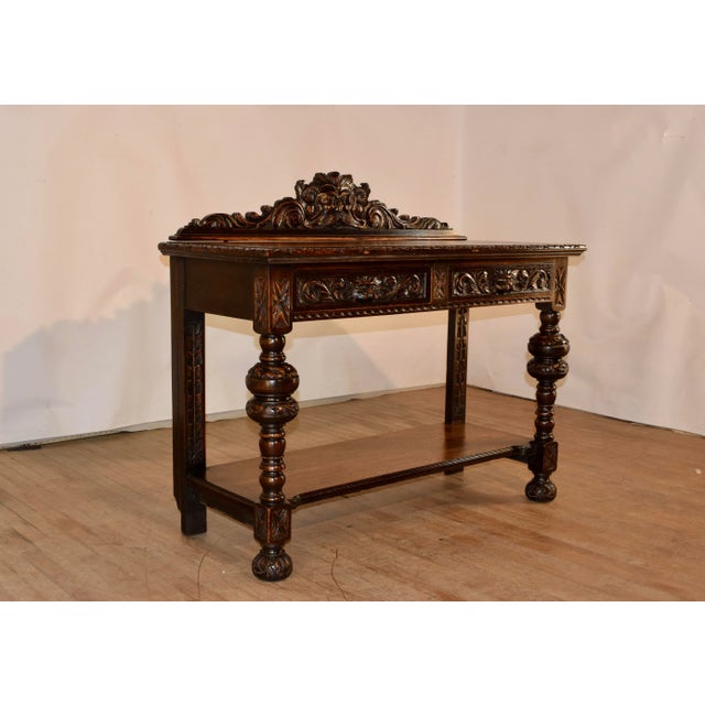 19th century oak console table from England with a wonderfully detailed hand carved backsplash over the top of the table,...