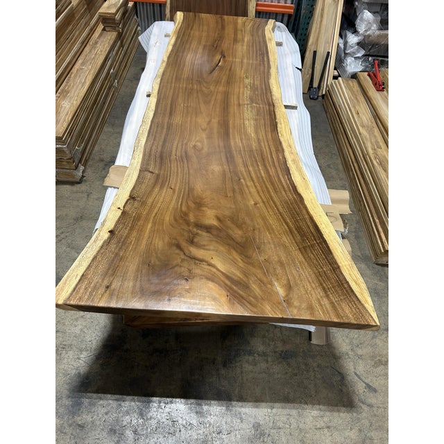 One tree. One top. One of one. A true single-slab live edge table: one continuous cross-section of a single Saman tree...
