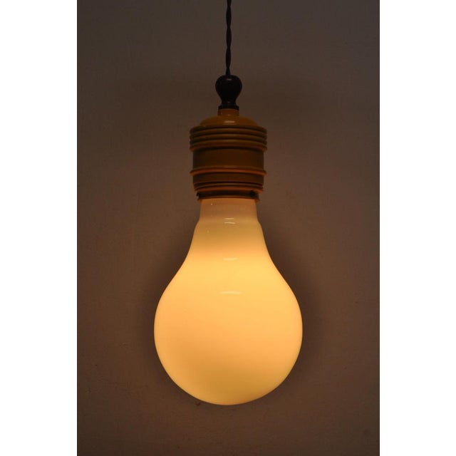 Two beautiful oversized bulb lamps in metal and opaline glass. The lamps were made in the 60s and still have the original...