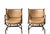 Pair of substantial, leather campaign chairs featuring curved metal/iron frames, leather wrapped arms, leather tassels,...