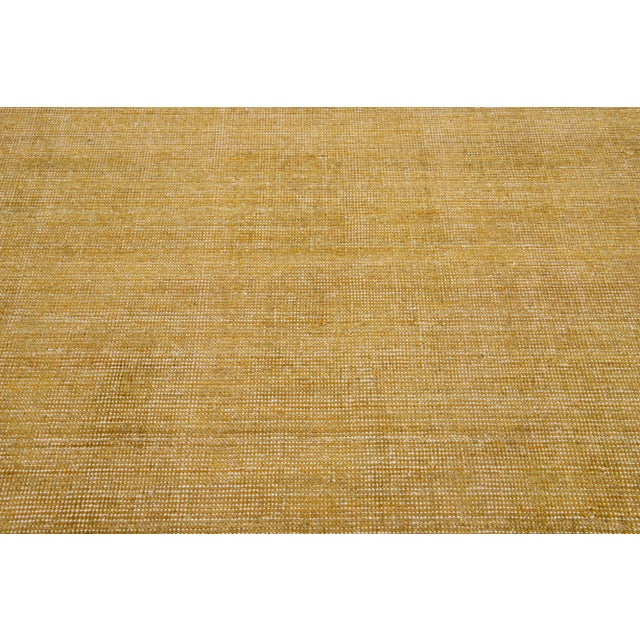Beautiful Modern Indian Loop hand-knotted wool rug with a light brown color field. This piece has an all-over solid...