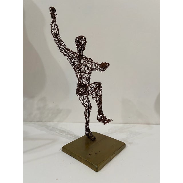 Very fun whimsical accent sculptural piece The metal wire has a rusted finish and mounted to a gold painted wood base....