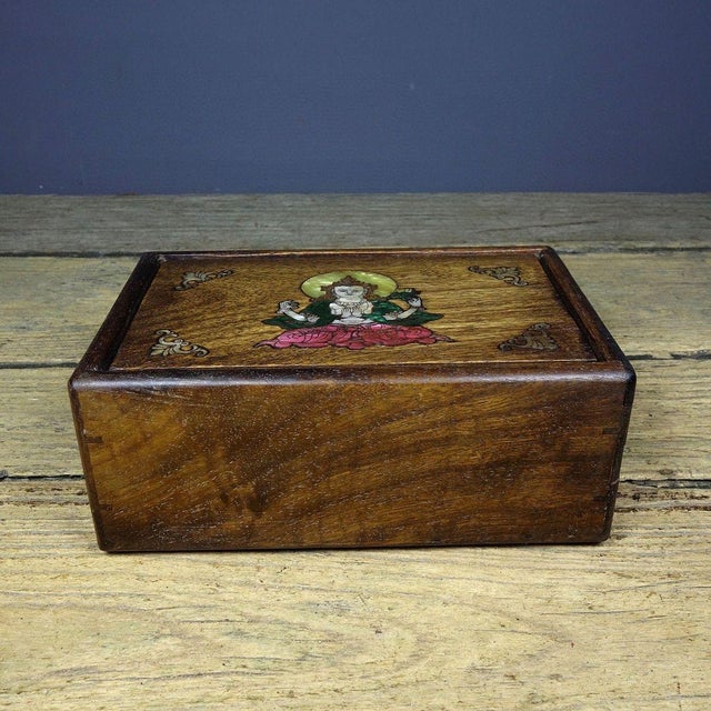 This is a captivating vintage Chinese wooden box, featuring a stunning inlaid image of a Buddhist deity on the lid. More...