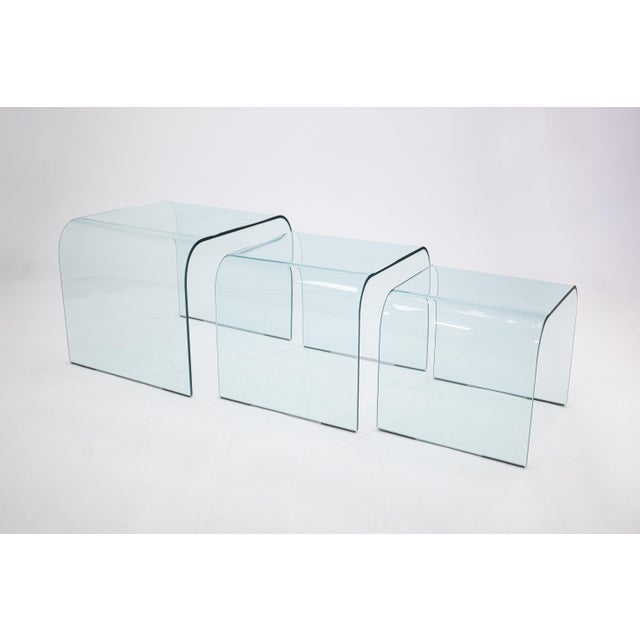 A set of 3 Fiam Italia waterfall glass nesting tables. These tables are ultra chic, and super functional. They feature a...