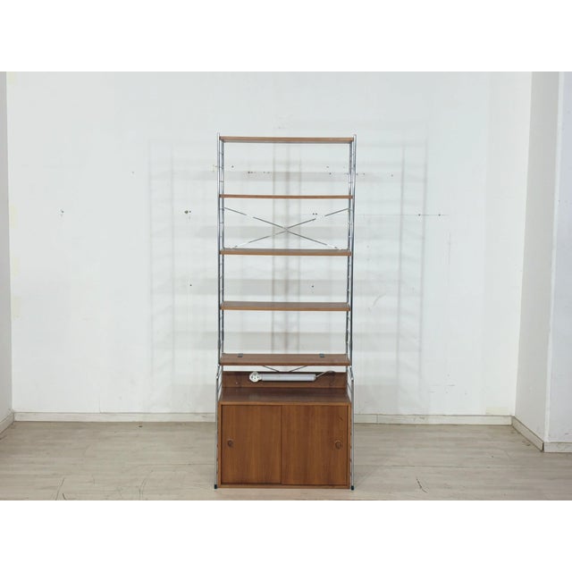 For sale is this timeless shelving system, combining airy aesthetics with functional design and fitting perfectly into...