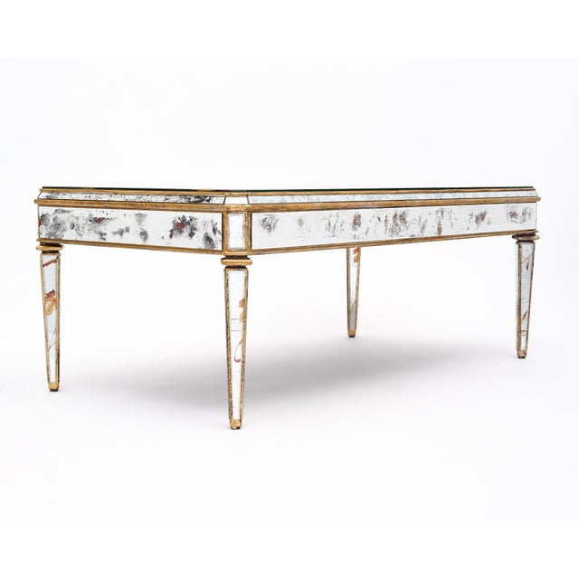 Coffee table from France in the Art Deco style. This table is entirely veneered with mirror and features striking...