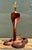 This striking vintage table lamp is a masterpiece of artisan woodcarving, featuring a dramatic cobra coiled in a powerful,...