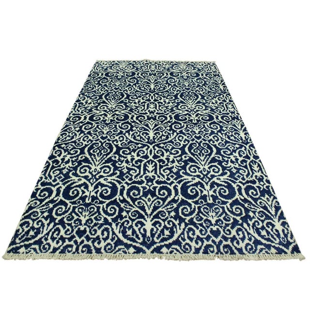 This elegant hand knotted rug features a modern fusion of beauty, with its interlocking geometric and minimalist pattern....