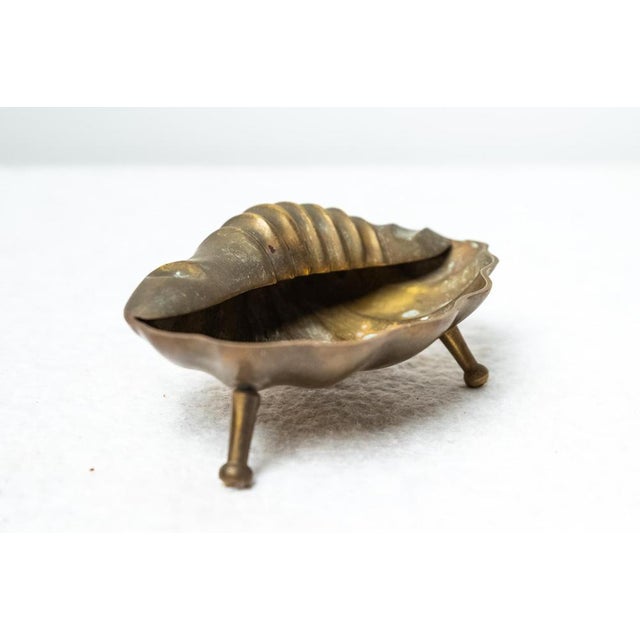 Vintage clamshell ashtray, Made in Italy, 1960s. Beautiful vintage brass ashtray in the shape of a shell. It was produced...
