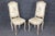 This elegant set of four paint-decorated Louis XV style dining chairs embodies the romance, grace, and refined...