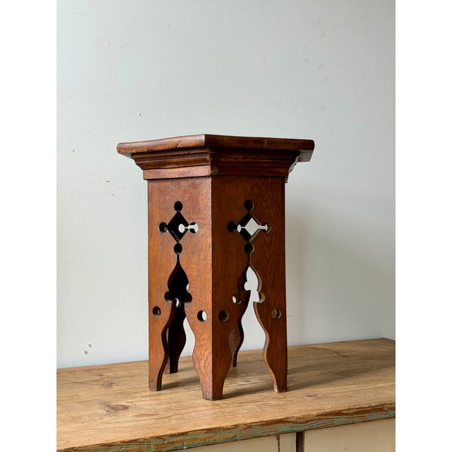 Small Arts & Crafts oak occasional table with a hexagonal top and Moorish-inspired pierced panels. A sculptural little...