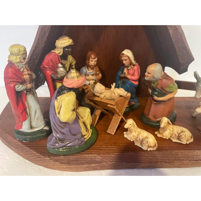 Offering a vintage 13 piece nativity set, made in West Germany. The wooden stable measures 15” wide x 6” deep x 11” high....