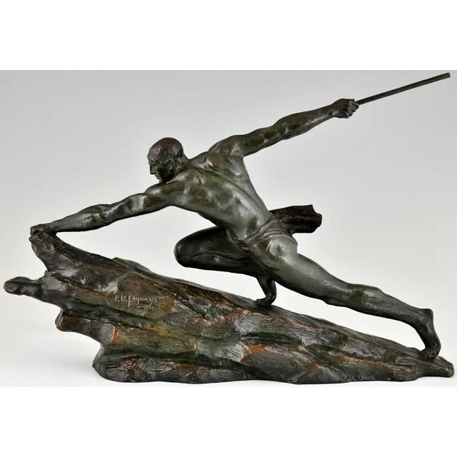Art Deco bronze sculpture athlete with spear signed by Pierre Le Faguays. The sculpture has a rich green patina with...