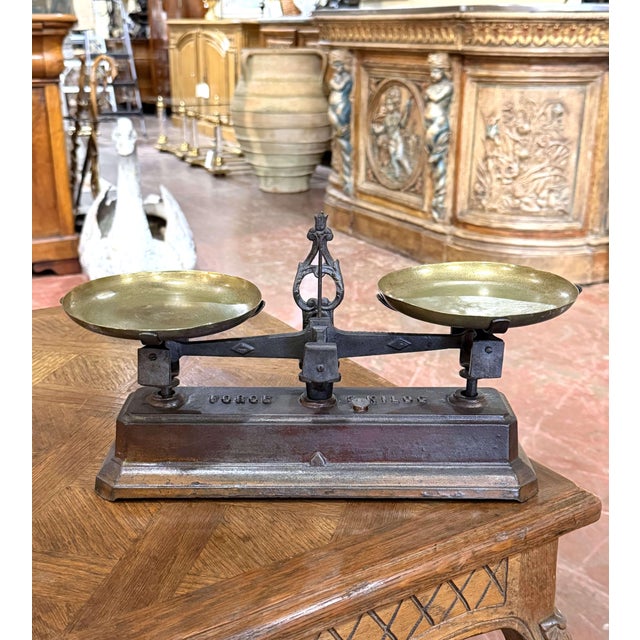 This handsome antique balance scale was crafted in France circa 1880. Made of cast iron, the substantial scale features a...