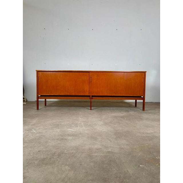 Teak sideboard with two sliding doors by Gianfranco Frattini, 1957 Teak sideboard with two sliding doors that open onto an...