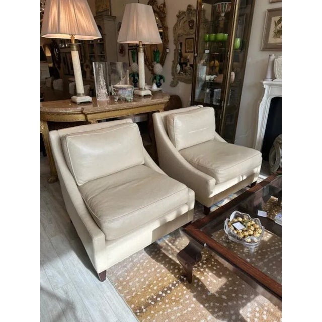 This is a pair of chairs from Barbara Barry for Baker. They are made of a vegan leather that is butter soft and off white...