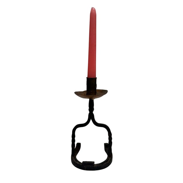 Charming vintage hand-forged iron candlestick featuring a rustic horseshoe-shaped base and twisted iron supports. Three...