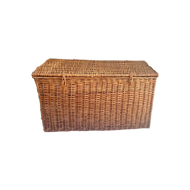 Charming antique English wicker trunk dating to the early 20th century, featuring a classic rectangular form and...