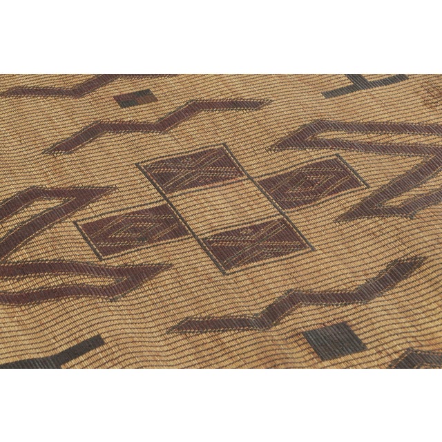 This vintage Moroccan mat is a primitive 4x4 Tuareg work from the nomadic tribe of the same name. Handwoven with reeds and...