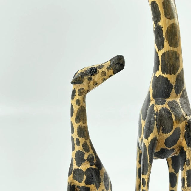 Hand-Carved Giraffe Sculpture from Kenya A charming hand-carved wooden sculpture from Kenya, depicting a graceful giraffe...