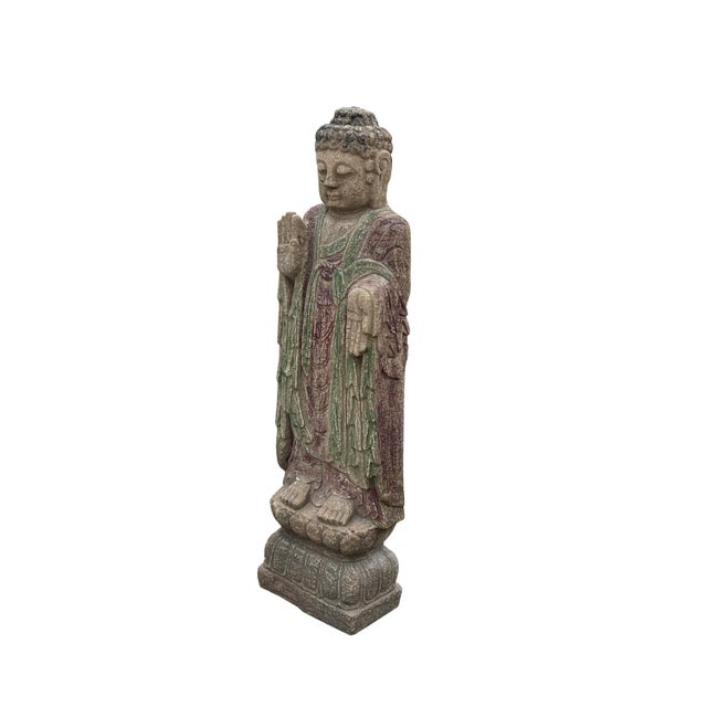 This is a standing Chinese Buddha carved from a rough surface grayish-brown color stone. It has Abhaya Mudra posture - No...