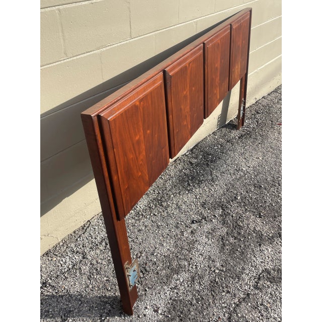 Headboard is constructed of solid wood with book matched walnut veneer. Four raised squares along the back add dimension...