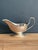 A classic silverplated gravy or sauce boat with a deep oval body, wide pouring lip, high looped handle with thumb-rest,...