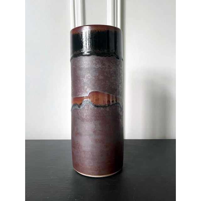 A ceramic vase in a slightly tapered cylinder form by potter Brother Thomas Bezanson (1929-2007). The minimalistic...