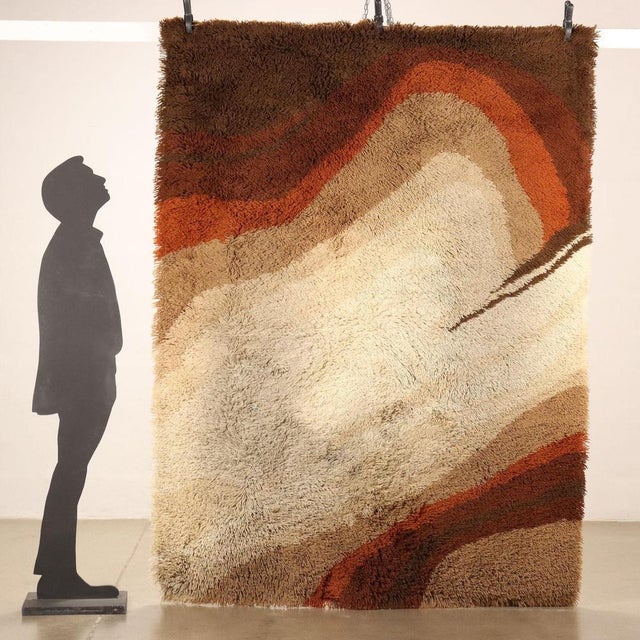 Vintage shaggy rug in large knot wool, machine manufacture. This piece is attributed to the mentioned designer/maker. It...