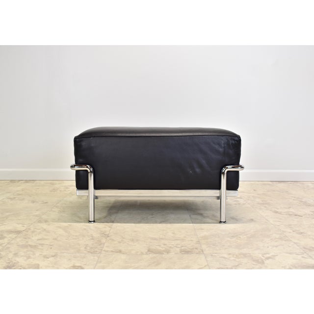 Genuine LC2 black leather and chrome ottomans circa the 2010s. Originally designed by Jeanneret Perriand for Le Corbusier...