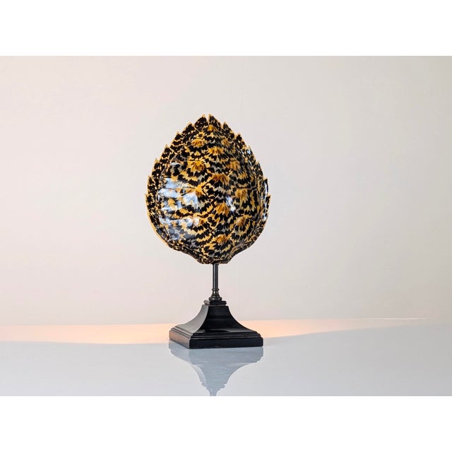 This table lamp reflects the French decorative aesthetic popularized by Maison Jansen in the 1970s. The piece features an...