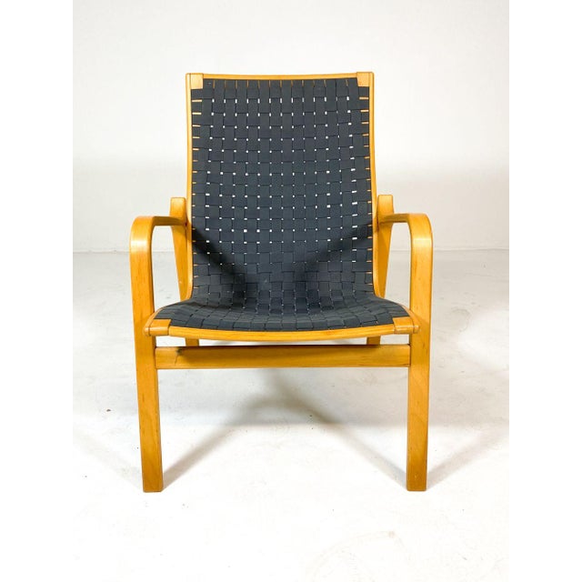 Scandinavian lounge chair with beech frame and woven upholstery in the style of Finn Ostergaard, c 1970s. The color looks...
