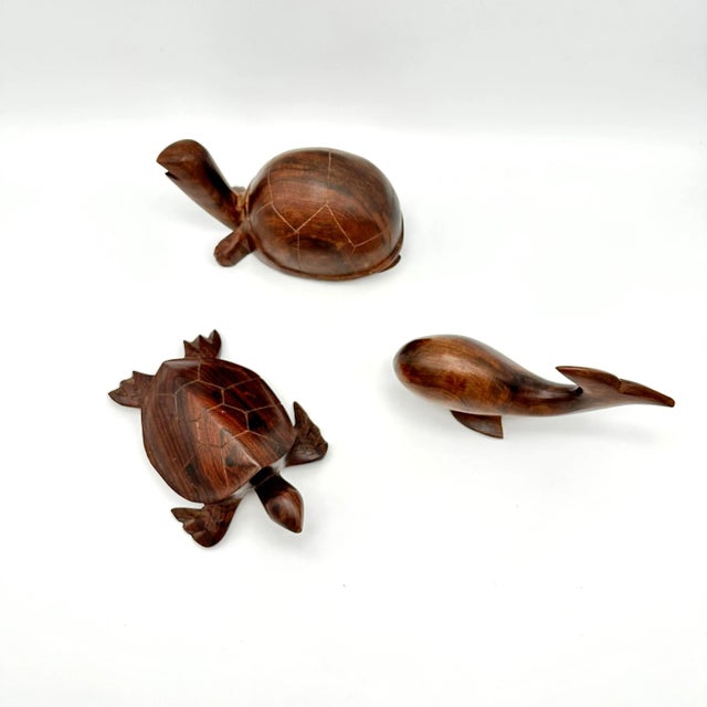 Add a touch of contemporary style to any room with this stunning set of three handcrafted wood figurines. The intricate...